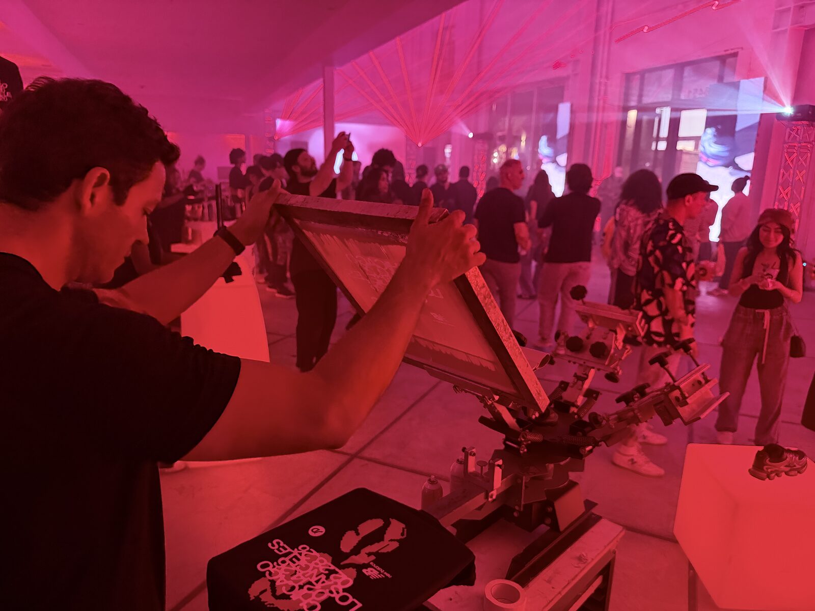 A press being opened at a live product launch merch station as a garment is finished