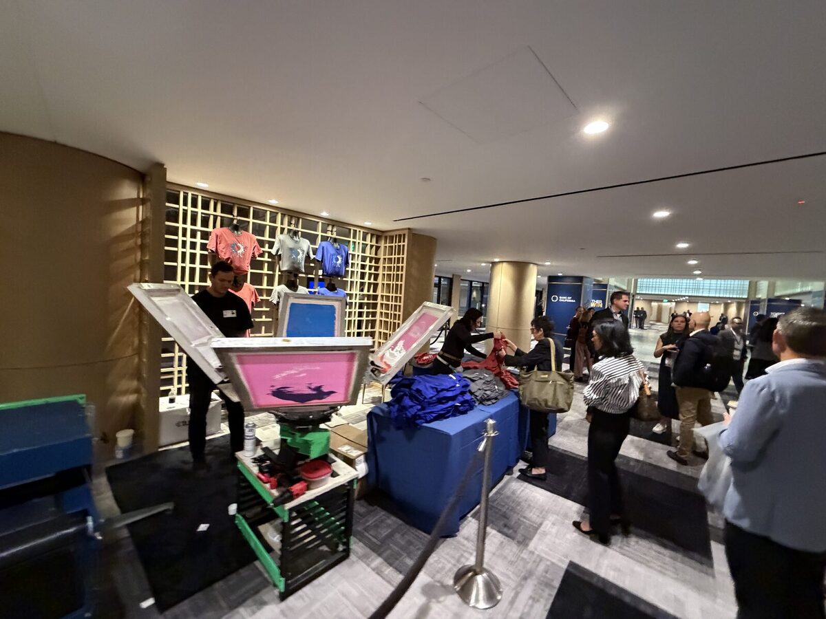 Guests packed around an event press station waiting for their items